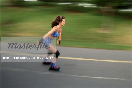 Woman In-Line Skating on Road