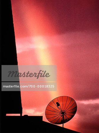 Silhouette of Satellite Dish With Rainbow at Sunset