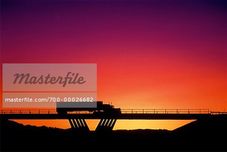 Silhouette of Transport Truck on Bridge at Sunset