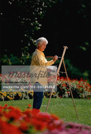 Mature Woman Painting in Garden