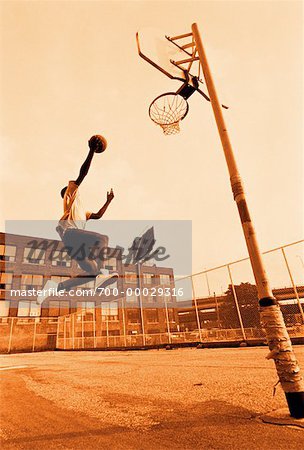 Man Playing Basketball Outdoors