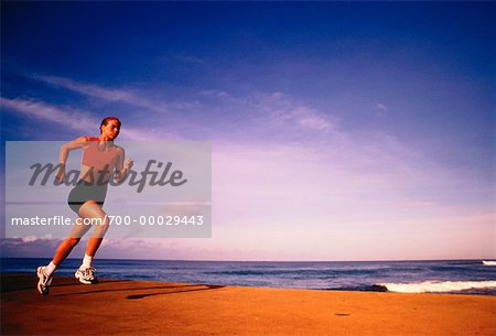 Femme en cours d'exécution sur la plage