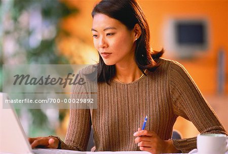 Businesswoman Sitting at Desk Using Computer