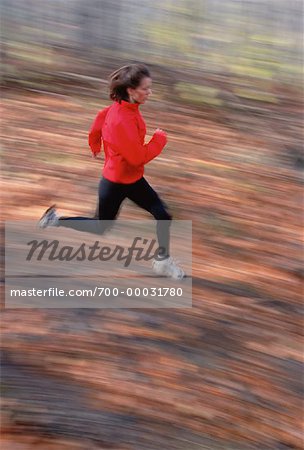 Blurred View of Runner in Autumn Gatineau Park, Quebec, Canada