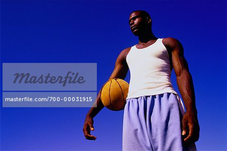 Man Holding Basketball Outdoors