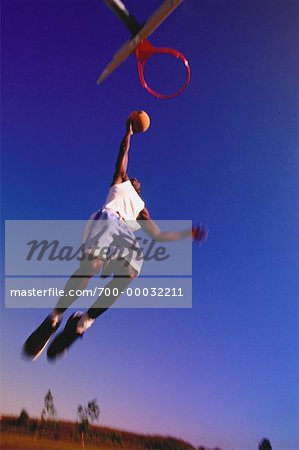 Man Playing Basketball Outdoors