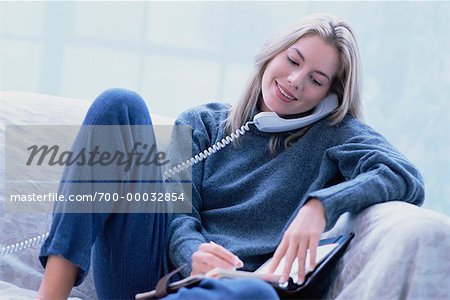 Woman Sitting on Sofa, Using Phone