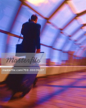 Businessman with Luggage and Cell Phone, Calgary, Alberta, Canada