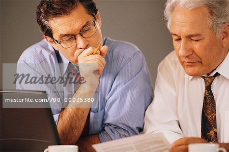 Businessmen Working on Laptop