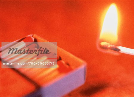 Close-Up of Lit Match and Matchbox