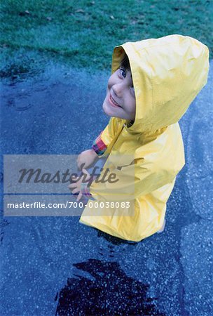 Portrait of Girl Playing in Puddle