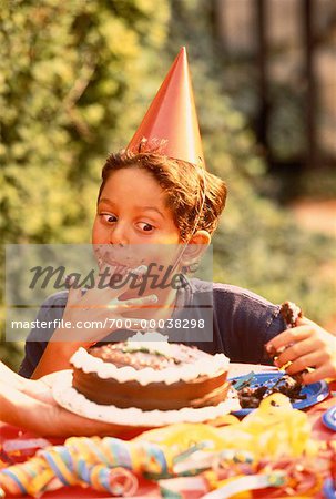 Boy Eating Cake Outdoors