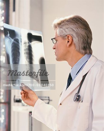 Mature Male Doctor Looking at X-Ray