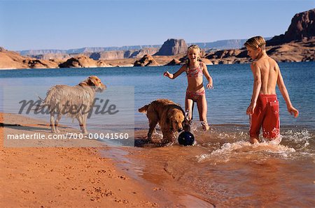 Boy and Girl in Swimwear on Beach With Dogs Lake Powell, Arizona, USA