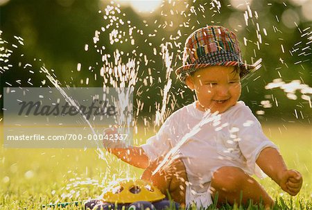 Child Playing with Sprinkler