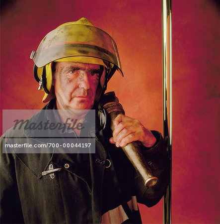 Portrait of Male Firefighter Holding Hose