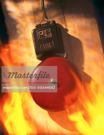 Close-Up of Fire Alarm Ringing Surrounded by Flames