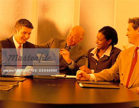 Business People Using Laptop Computer in Meeting