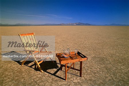 Deck Chair, Table and Glass of Water in Desert Nevada, USA