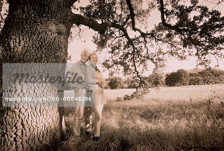 Portrait of Mature Couple Embracing near Tree