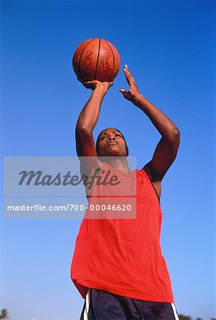 Woman Playing Basketball Outdoors