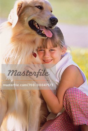 Portrait of Girl Hugging Dog Outdoors