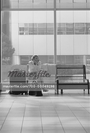 Businesswoman Sitting on Bench With Luggage in Terminal Toronto, Ontario, Canada