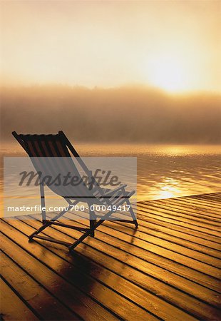 Beach Chair on Dock at Sunrise Meech Lake, Quebec, Canada