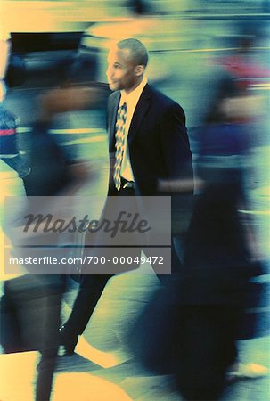 Businessman Walking on Busy Street