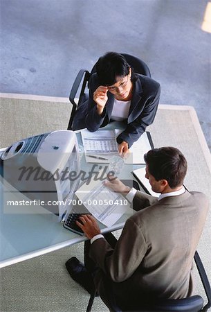 Overhead View of Businessman and Businesswoman in Meeting