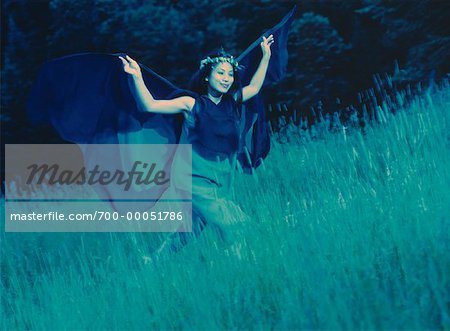 Woman in Butterfly Costume Running through Field