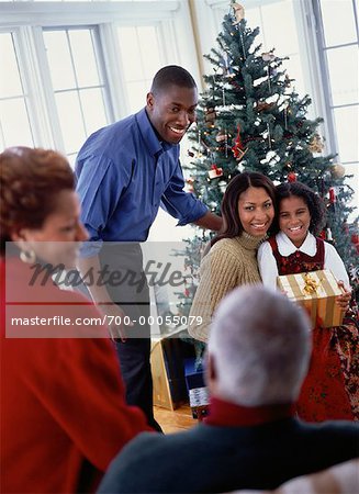 Family Gathered near Christmas Tree