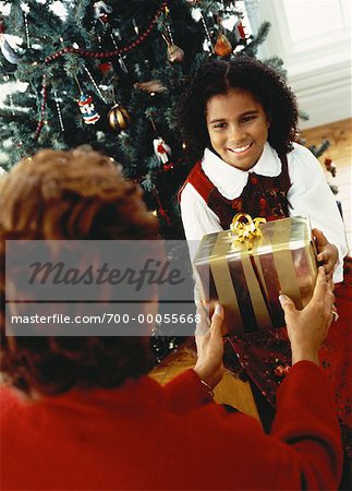 Grandmother Giving Christmas Gift to Granddaughter