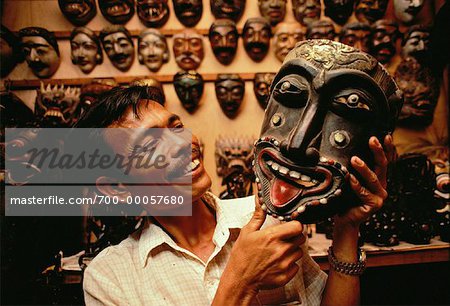 Man Holding Wooden Mask in Shop Bali, Indonesia