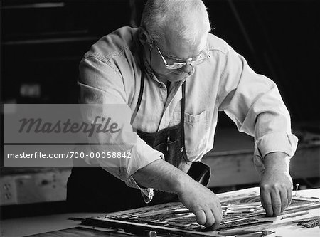 Mature Male Stained Glass Artisan In Workshop