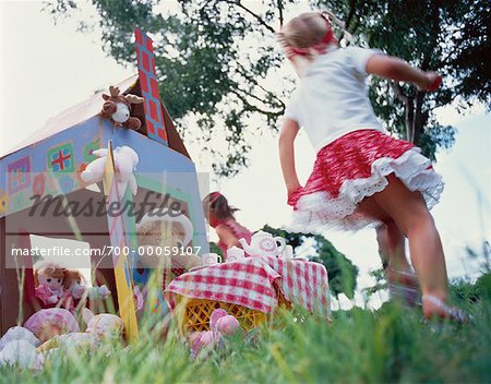 Girls Having Tea Party with Plush Toys Outdoors