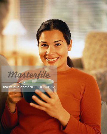 Portrait of Woman Sitting on Sofa Holding Mug