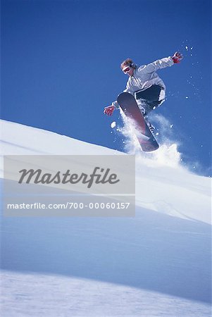 Snowboarder Jumping over Hill Jungfrau Region, Switzerland