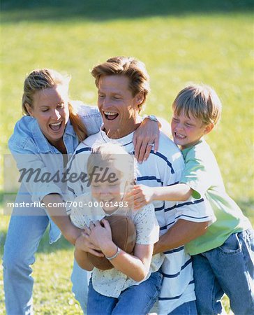 Family Playing Football Outdoors