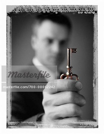 Portrait of Businessman Holding Skeleton Key