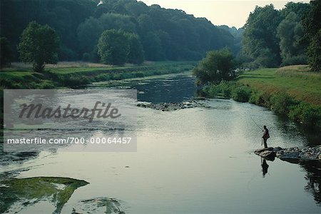 Man Fly Fishing from Rocks River Nore, Ireland