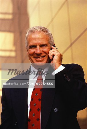 Portrait of Mature Businessman Using Cell Phone Outdoors