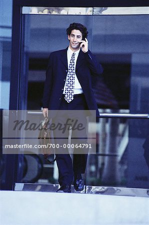 Businessman Carrying Briefcase Using Cell Phone