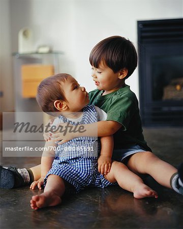 Boy and Baby Sitting on Floor