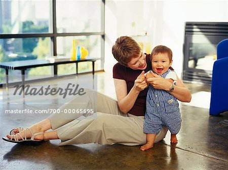 Mother Sitting on Floor with Baby