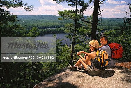 Hiking Couple Sitting on Rocks Belgrade Lakes, Maine, USA