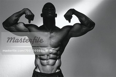 Portrait of Male Body Builder Flexing Muscles
