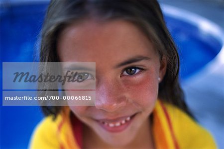Portrait of Girl Wrapped in Towel Near Swimming Pool