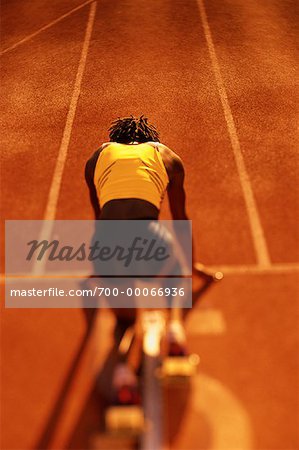 Back View of Woman at Starting Position on Running Track