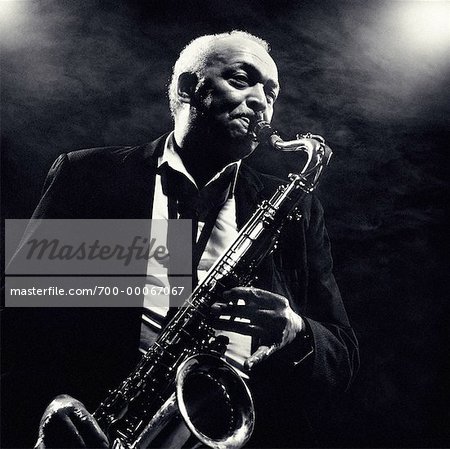 Mature Man Playing Saxophone in Smoky Room